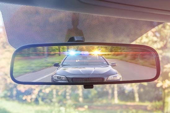 Blinking Police Lights in Rear View Mirror