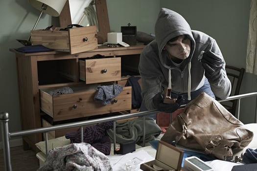 burglar stealing jewelry in home