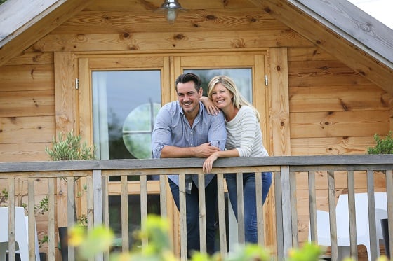 couple standing on porch smiling