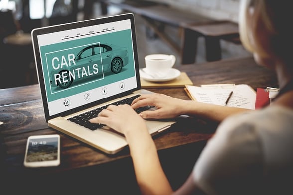 girl on laptop looking for car rentals online