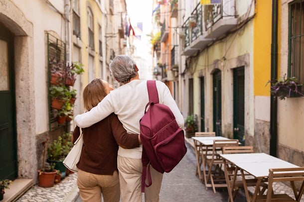 older couple walking down european street together