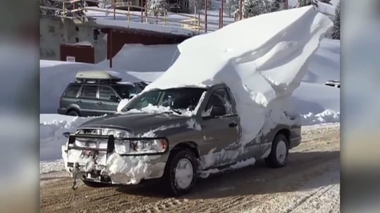large snow stack on driving truck